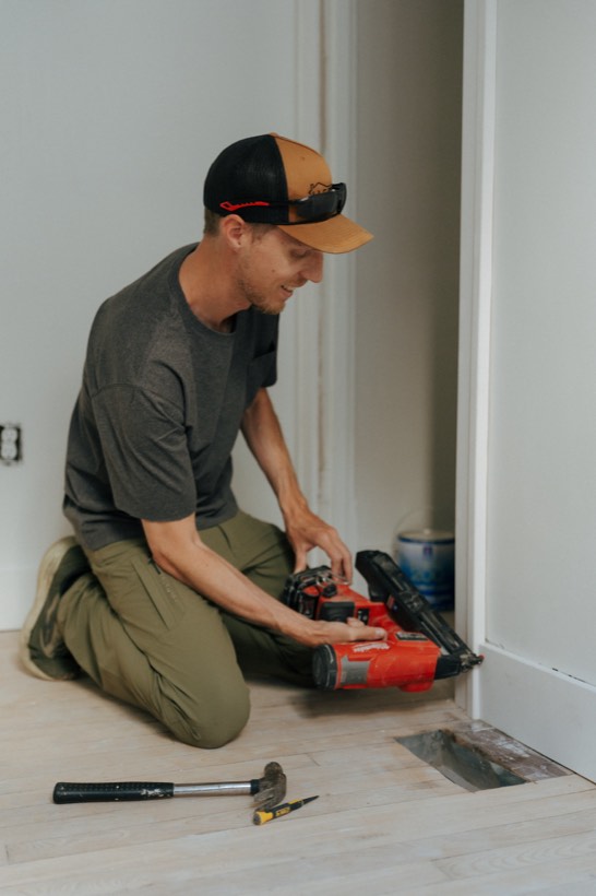 Dave Arthur nailing door trim with a nail gun